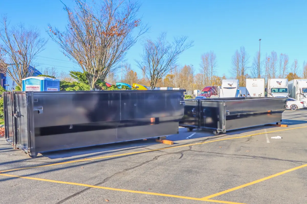 Professional dumpster rental service with roll-off container on residential driveway in Cheltenham